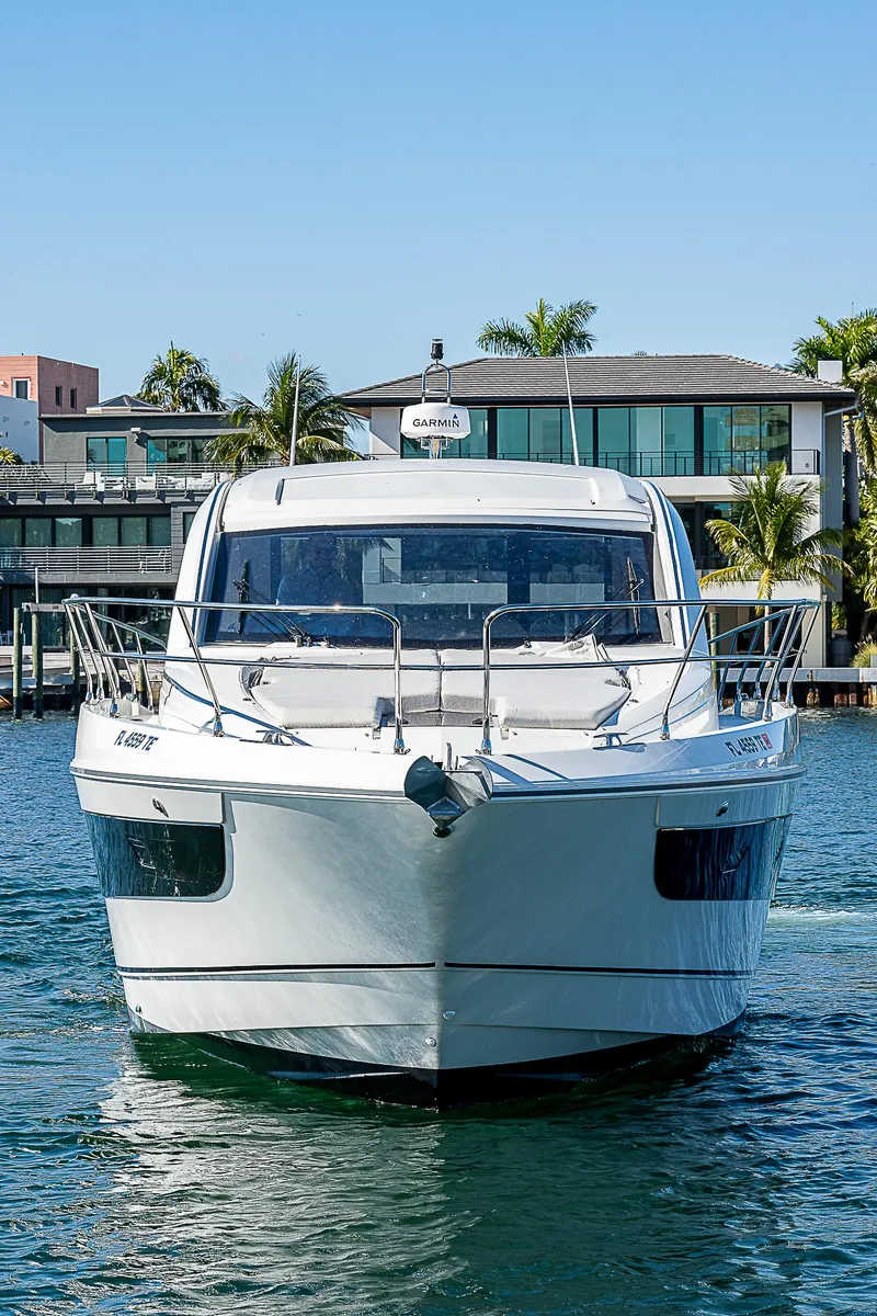 Slide: The Image of Beneteau Gran Turismo 45 Yacht 2022 on calm water near modern villa. - 3