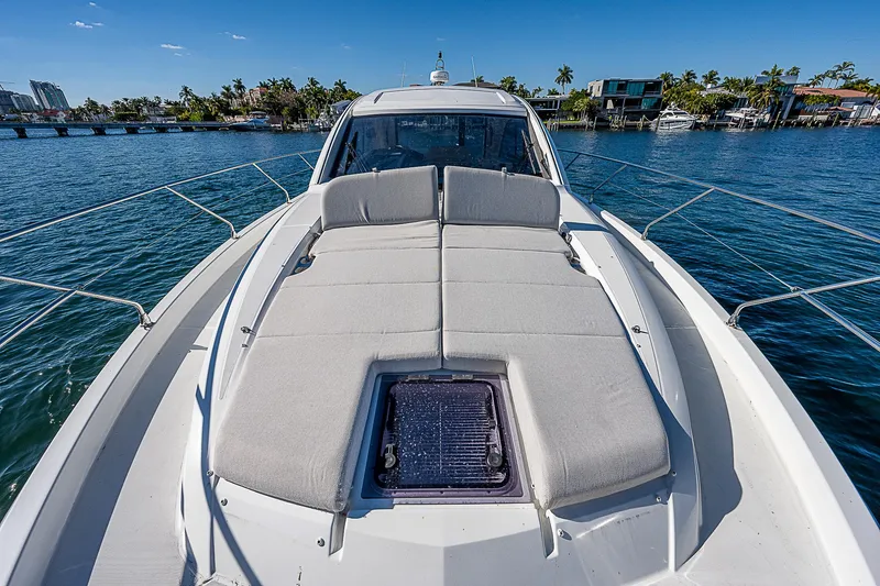 Slide: The Image of 2022 Beneteau Gran Turismo 45 yacht with sunbathing area on deck, docked in a marina. - 30