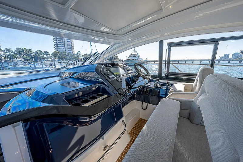 Slide: The Image of Interior helm of 2022 Beneteau Gran Turismo 45 yacht with marina view. - 43