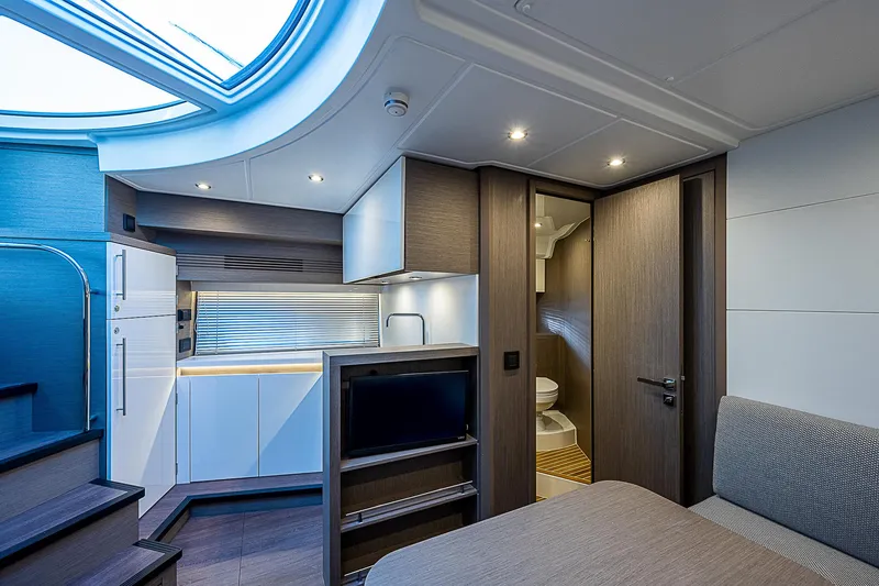 Slide: The Image of Interior of 2022 Beneteau Gran Turismo 45 yacht with modern kitchen and cozy living area. - 53