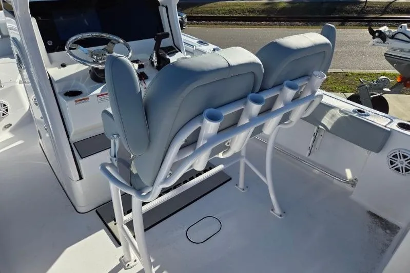 Slide: The Image of 2026 Sportsman Open 212 Center Console boat interior with dual seats and rod holders. - 12