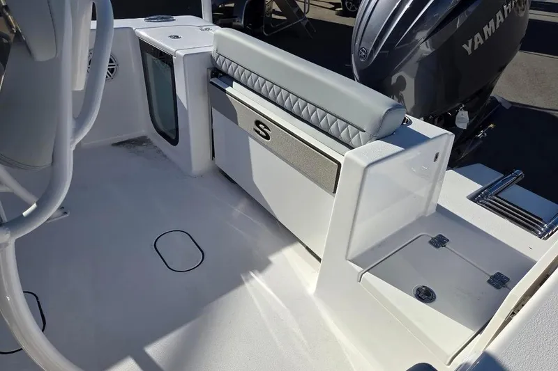 Slide: The Image of 2026 Sportsman Open 212 Center Console boat interior with Yamaha engine, featuring seating and storage. - 14
