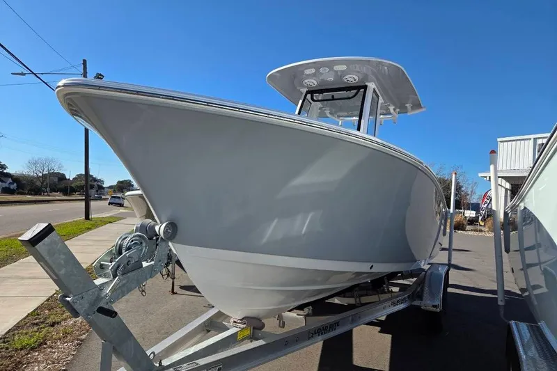 Slide: The Image of 2026 Sportsman Open 212 Center Console boat on trailer, parked outdoors. - 3