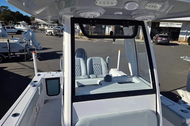 Slide: The Image of 2026 Sportsman Open 212 Center Console boat interior at a marina. - 6