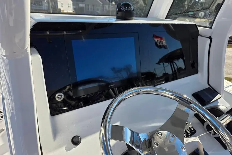 Slide: The Image of 2026 Sportsman Open 212 Center Console dashboard with steering wheel and navigation display. - 8