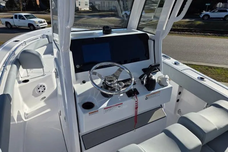 Slide: The Image of 2026 Sportsman Open 212 Center Console boat interior with steering wheel and dashboard. - 9