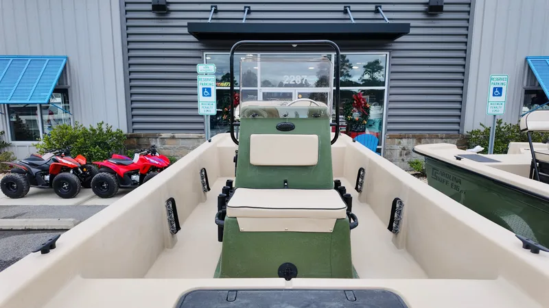 Slide: The Image of 2025 Carolina Skiff E18 JVX CC Swamp Edition boat, beige interior, outdoor display. - 10