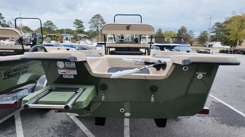 Slide: The Image of 2025 Carolina Skiff E18 JVX CC Swamp Edition boat, rear view in parking lot. - 3