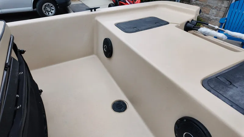 Slide: The Image of 2025 Carolina Skiff E18 JVX CC Swamp Edition boat interior with speakers and storage compartments. - 6