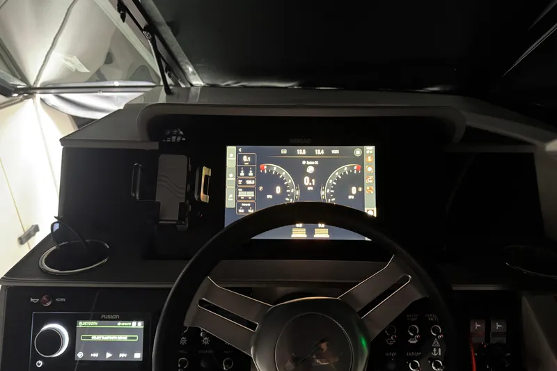 Slide: The Image of 2025 Sea Ray SDX 290 Outboard with twin Mercury engines docked by waterfront homes. - 11