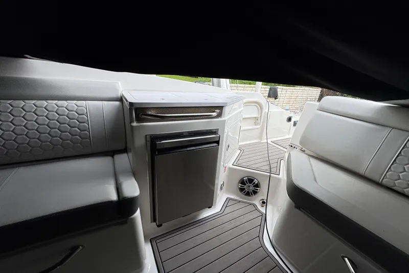 Slide: The Image of 2025 Sea Ray SDX 290 Outboard with dual Mercury engines docked by waterfront homes. - 12