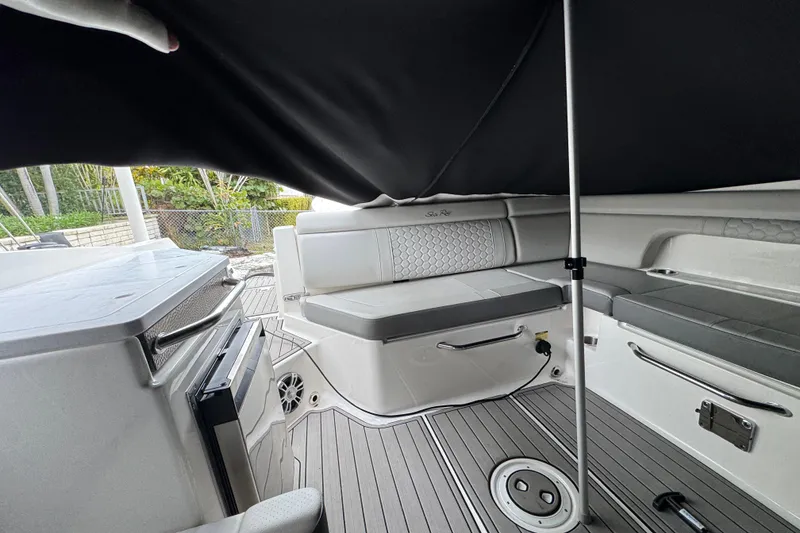 Slide: The Image of 2025 Sea Ray SDX 290 Outboard boat with dual Mercury engines docked by waterfront. - 13