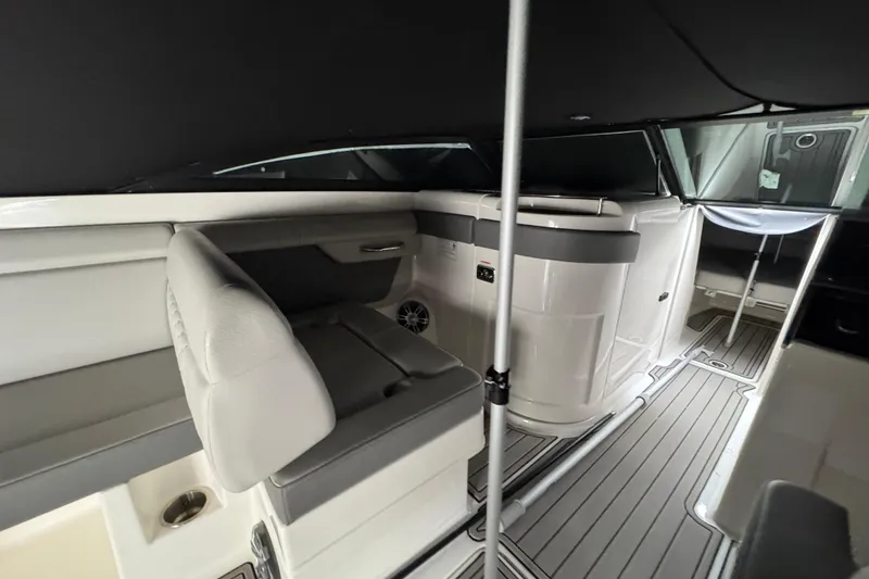 Slide: The Image of 2025 Sea Ray SDX 290 Outboard boat docked in a serene waterfront setting. - 15