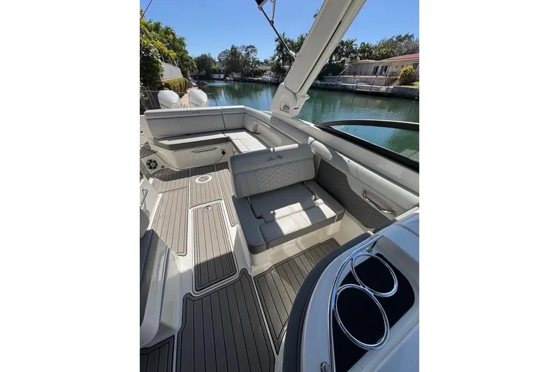 Slide: The Image of 2025 Sea Ray SDX 290 Outboard boat interior with luxurious seating and scenic water view. - 23
