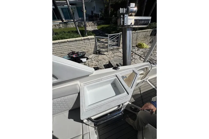 Slide: The Image of 2025 Sea Ray SDX 290 Outboard boat interior with sink and seating area. - 31