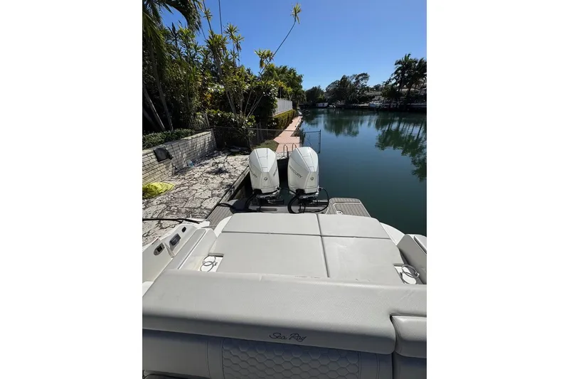 Slide: The Image of 2025 Sea Ray SDX 290 Outboard at dock, featuring dual engines and luxurious seating. - 32