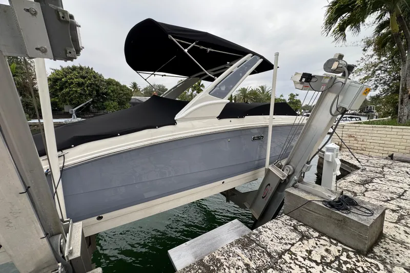 Slide: The Image of 2025 Sea Ray SDX 290 Outboard boat docked by a scenic waterfront. - 7