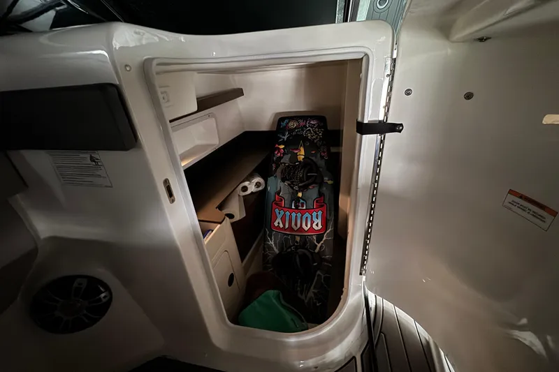 Slide: The Image of 2025 Sea Ray SDX 290 Outboard boat on lift, covered and docked by water. - 8