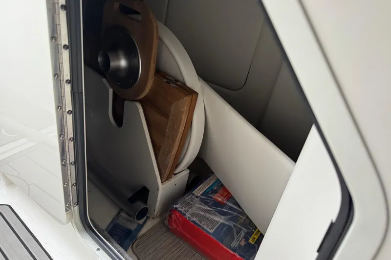 Slide: The Image of 2025 Sea Ray SDX 290 Outboard dashboard with digital display and steering wheel. - 9