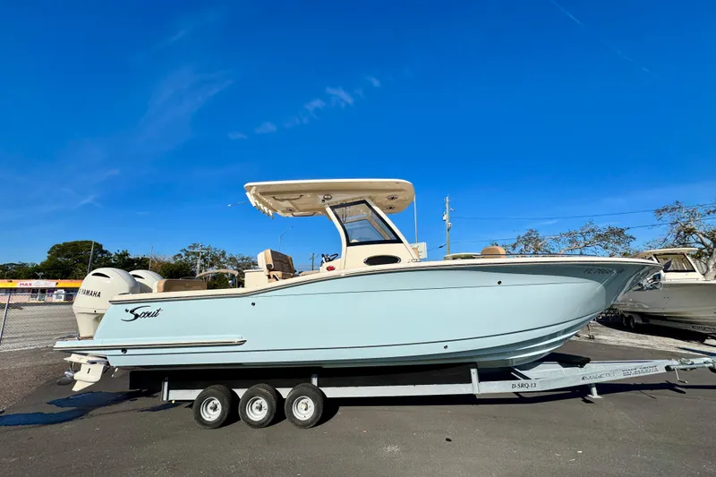 The Image of 2021 Scout 277 LXF boat on trailer under clear blue sky. - 0