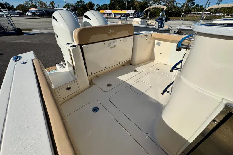Slide: The Image of 2021 Scout 277 LXF boat interior with dual engines and spacious deck. - 12