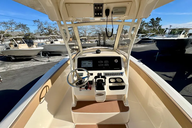 Slide: The Image of 2021 Scout 277 LXF boat cockpit with steering wheel and control panel. - 16