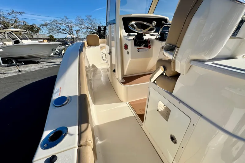 Slide: The Image of 2021 Scout 277 LXF boat interior with helm and seating area. - 19