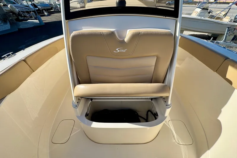 Slide: The Image of 2021 Scout 277 LXF boat interior with tan seating and storage compartment. - 24