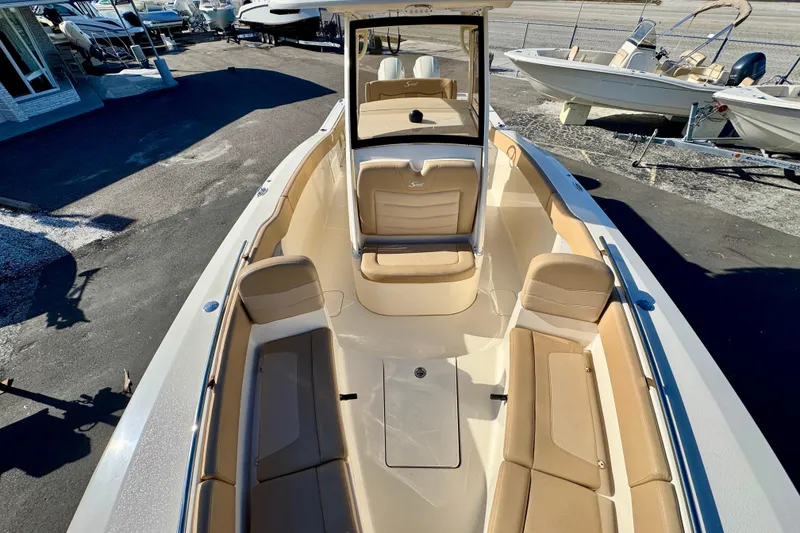 Slide: The Image of 2021 Scout 277 LXF boat interior with tan seating and spacious layout. - 25