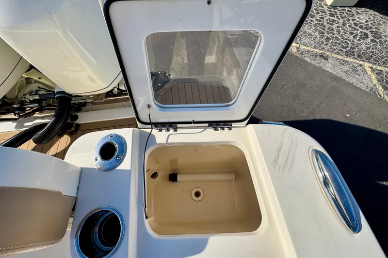 Slide: The Image of Open storage compartment on a 2021 Scout 277 LXF boat, showcasing interior details. - 28