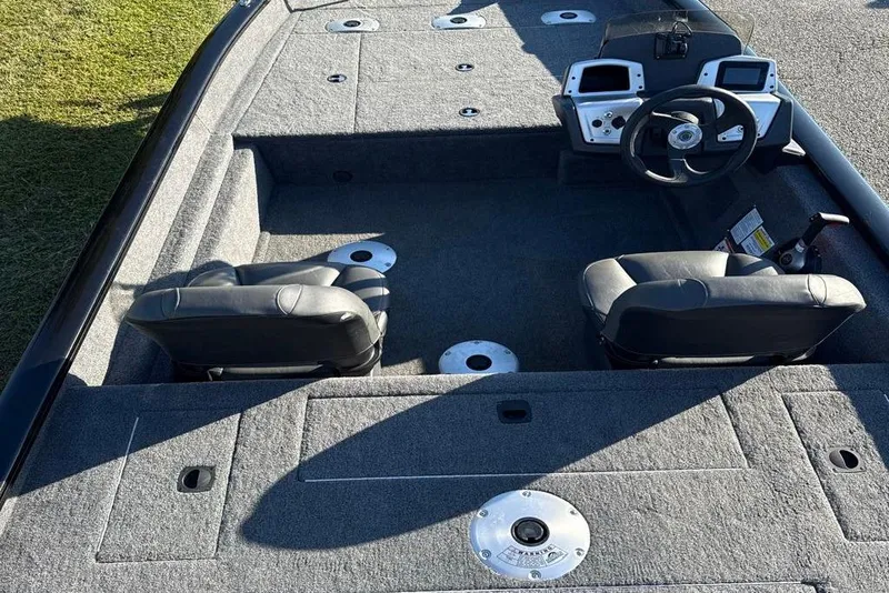 Slide: The Image of 2026 Bass Tracker Pro Team 175 boat interior with dual seats and steering console. - 3