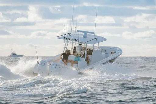Slide: The Image of Manufacturer Provided Image: 2026 Jupiter 40 boat cruising on ocean waves under a cloudy sky. - 1
