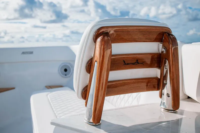 Slide: The Image of Manufacturer Provided Image: Luxury seating on a 2026 Jupiter 40 boat, featuring polished wood and white upholstery. - 7