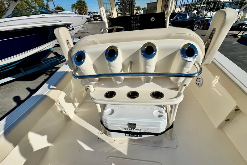 Slide: The Image of 2026 Scout 240 XSF boat interior with rod holders and cooler on deck. - 11