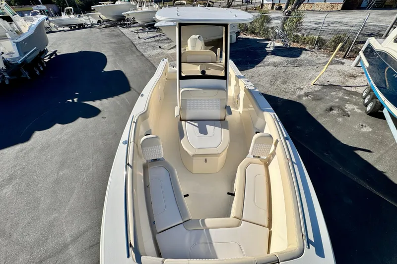 Slide: The Image of 2026 Scout 240 XSF boat with spacious seating and sleek design in a marina setting. - 24