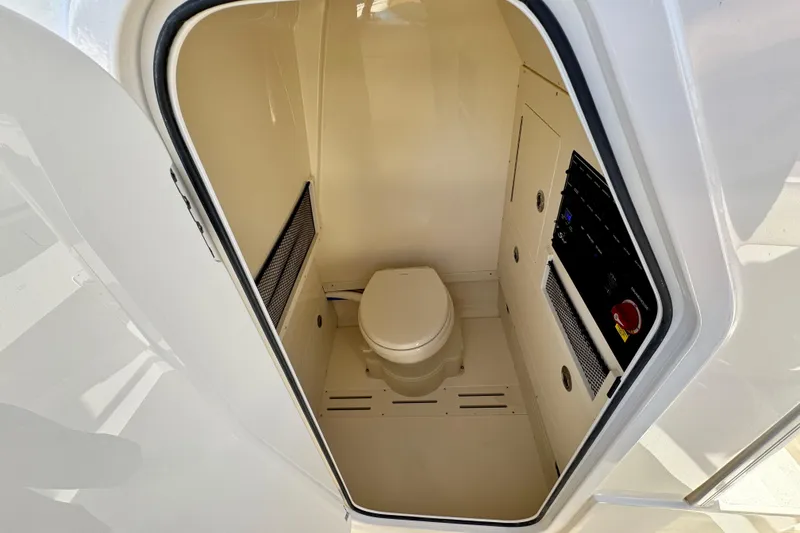Slide: The Image of 2026 Scout 240 XSF boat interior with compact marine toilet. - 26