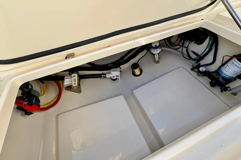 Slide: The Image of 2026 Scout 240 XSF boat compartment with wiring and components visible. - 30