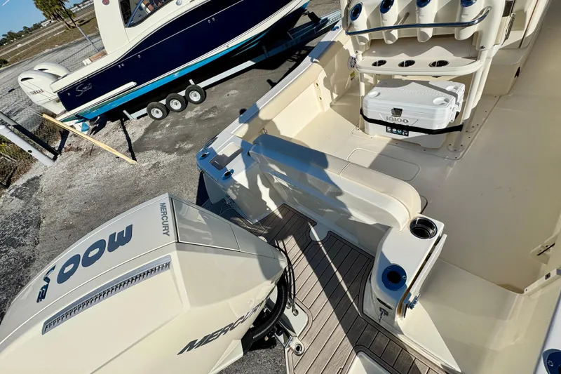 Slide: The Image of 2026 Scout 240 XSF boat interior with Mercury engine and Igloo cooler. - 6