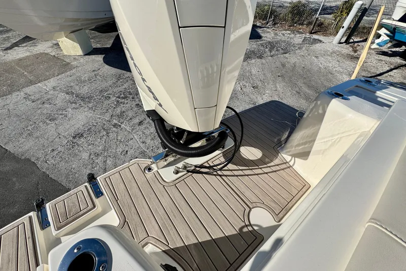 Slide: The Image of 2026 Scout 240 XSF boat with outboard motor and teak deck detail. - 7