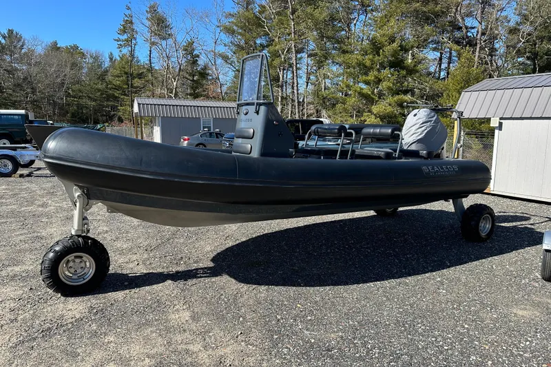Slide: The Image of 2019 Sealegs 7.1 RIB amphibious boat with wheels, parked outdoors. - 0