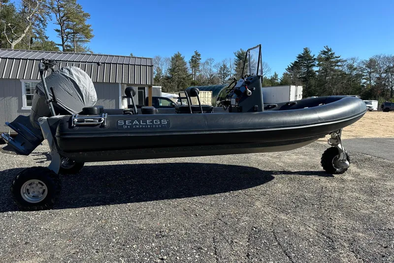Slide: The Image of 2019 Sealegs 7.1 RIB amphibious boat on land with wheels extended. - 1