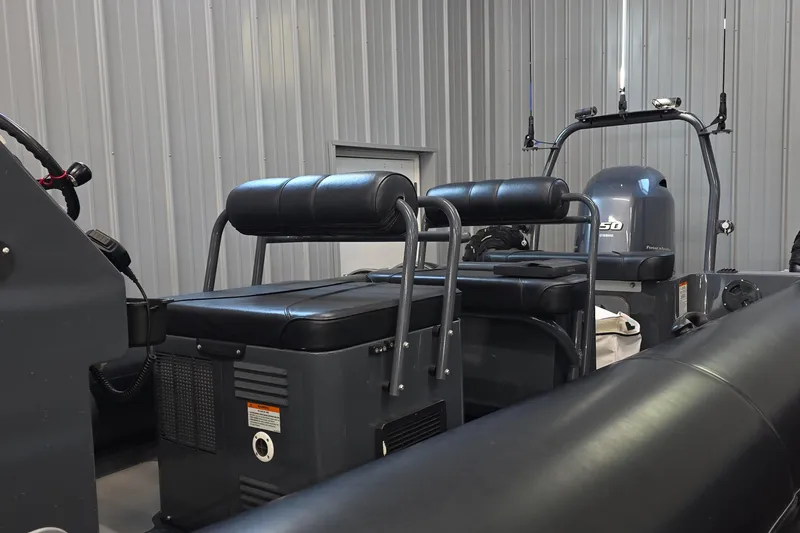 Slide: The Image of 2019 Sealegs 7.1 RIB boat interior with seating and controls in a storage facility. - 10