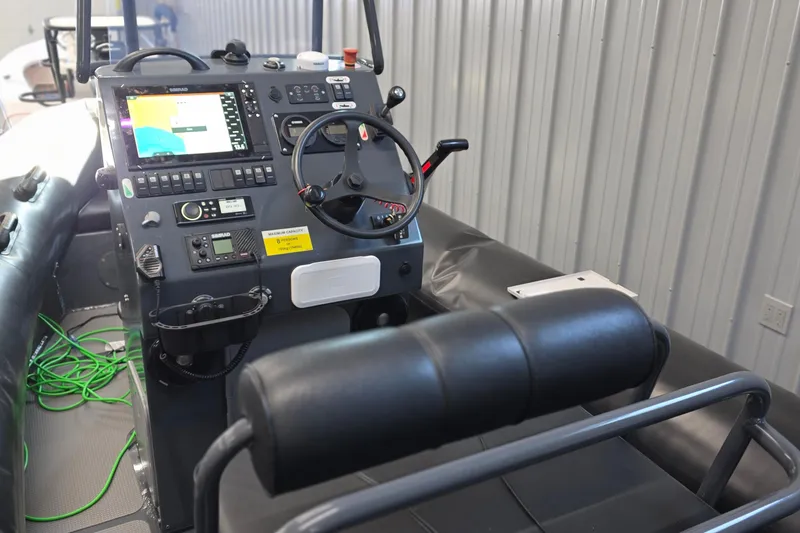 Slide: The Image of 2019 Sealegs 7.1 RIB boat cockpit with advanced navigation controls and steering wheel. - 12