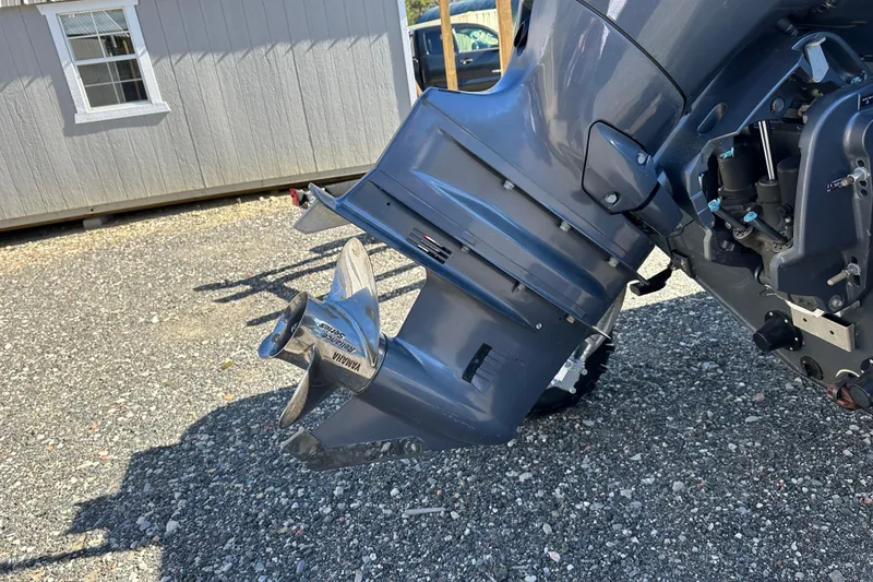 Slide: The Image of Outboard motor of a 2019 Sealegs 7.1 RIB on gravel surface. - 26