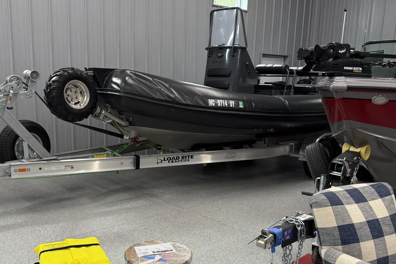 Slide: The Image of 2019 Sealegs 7.1 RIB on Load Rite trailer in garage setting. - 3