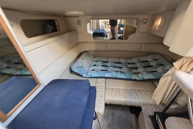 Slide: The Image of Interior cabin of a 1999 Sea Ray 340 Sundancer with a cozy bed setup. - 15