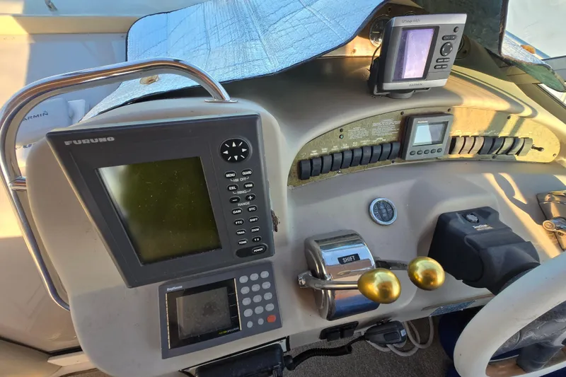 Slide: The Image of 1999 Sea Ray 340 Sundancer helm with navigation equipment and controls. - 20