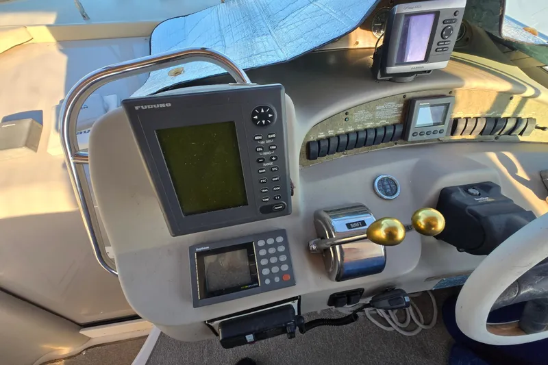 Slide: The Image of Control panel of a 1999 Sea Ray 340 Sundancer boat with navigation equipment. - 21