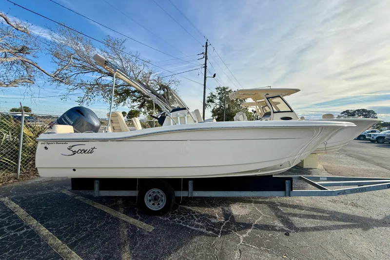 Slide: The Image of 2026 Scout 195 Sport Dorado boat on trailer, parked outdoors. - 1