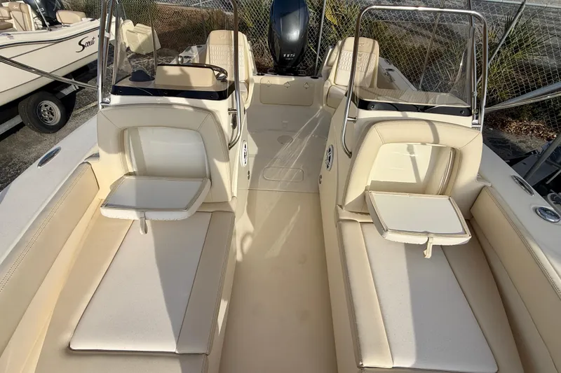 Slide: The Image of 2026 Scout 195 Sport Dorado boat interior with beige seating and console. - 11